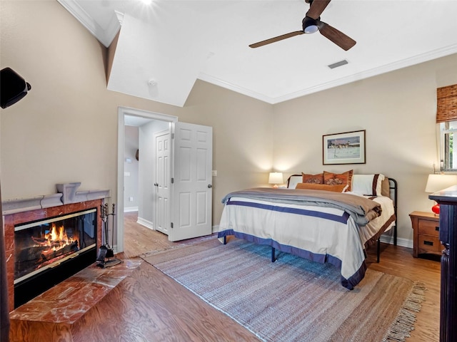 6037 Lake Erie Rd, Groveland, FL 34736 - bedroom with ornamental molding, a premium fireplace, wood finished floors, baseboards, and ceiling fan