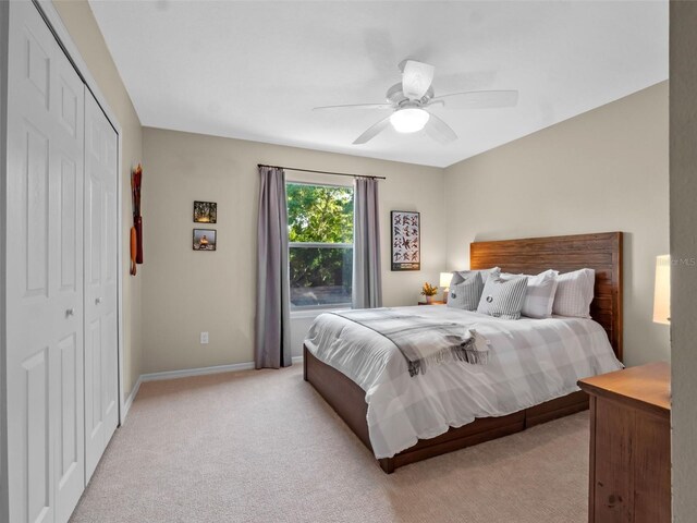 6037 Lake Erie Rd, Groveland, FL 34736 - bedroom featuring light carpet, a closet, a ceiling fan, and baseboards
