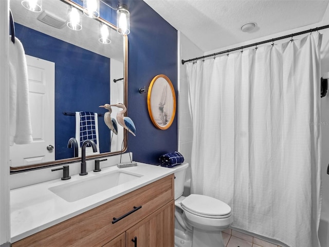 6037 Lake Erie Rd, Groveland, FL 34736 - full bathroom with tile patterned floors, toilet, vanity, and a textured ceiling