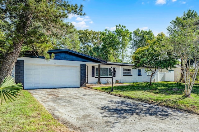 505 Lake Shore Dr, Maitland, FL 32751 - ranch-style home with a front lawn, driveway, fence, a garage, and brick siding