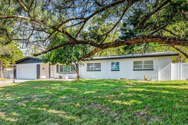505 Lake Shore Dr, Maitland, FL 32751 - ranch-style house featuring a front lawn, driveway, fence, a garage, and brick siding
