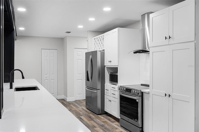 505 Lake Shore Dr, Maitland, FL 32751 - kitchen featuring a sink, appliances with stainless steel finishes, wall chimney exhaust hood, dark wood-style flooring, and recessed lighting