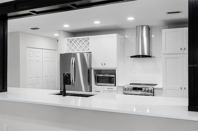 505 Lake Shore Dr, Maitland, FL 32751 - kitchen featuring white cabinets, wall chimney exhaust hood, stainless steel appliances, and visible vents
