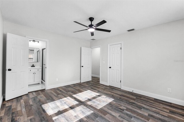 505 Lake Shore Dr, Maitland, FL 32751 - unfurnished bedroom featuring dark wood finished floors, visible vents, baseboards, and ensuite bathroom