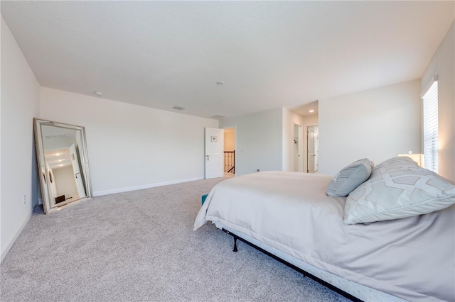 bedroom with carpet flooring, baseboards, recessed lighting, and connected bathroom