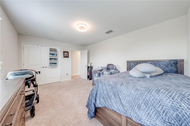 carpeted bedroom with a closet, baseboards, and visible vents