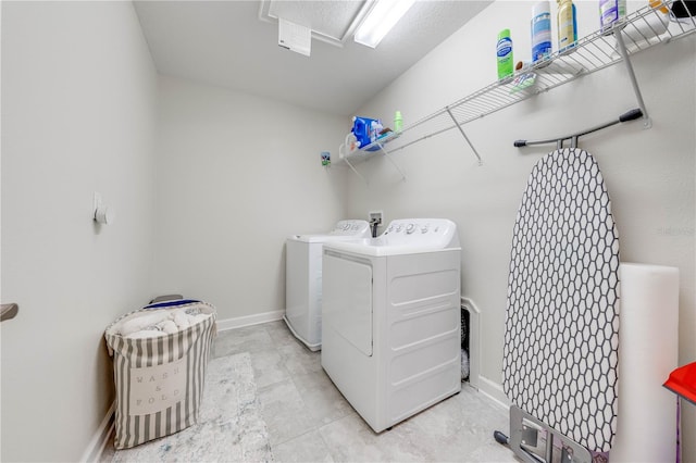 washroom with washer and dryer, laundry area, and baseboards
