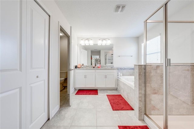 full bath with vanity, a stall shower, tile patterned floors, toilet, and a bath