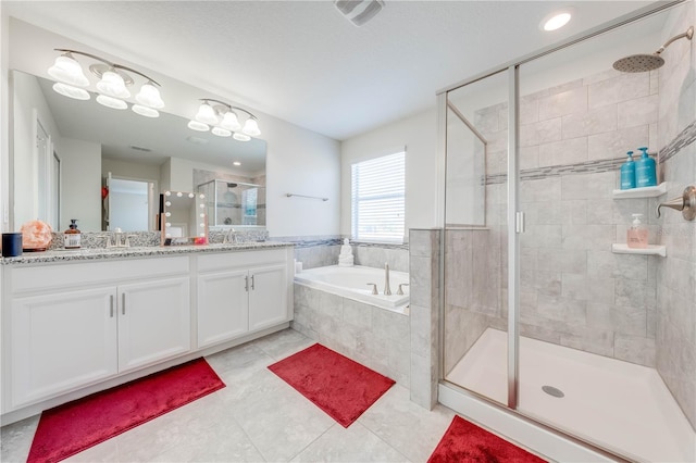 full bath featuring a sink, a bath, double vanity, and a stall shower