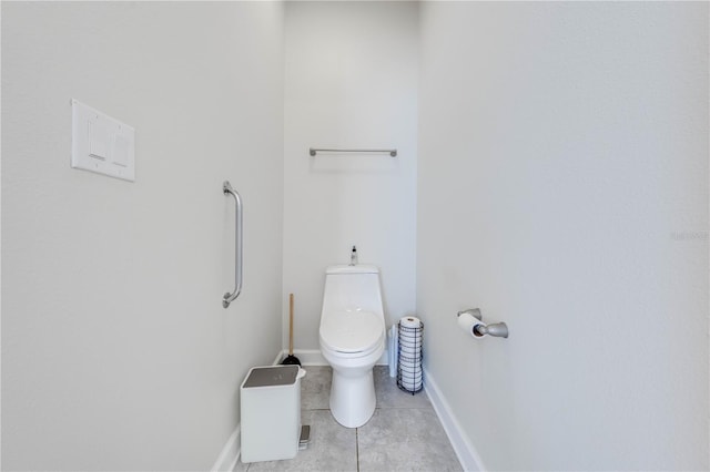 bathroom with toilet, tile patterned floors, and baseboards
