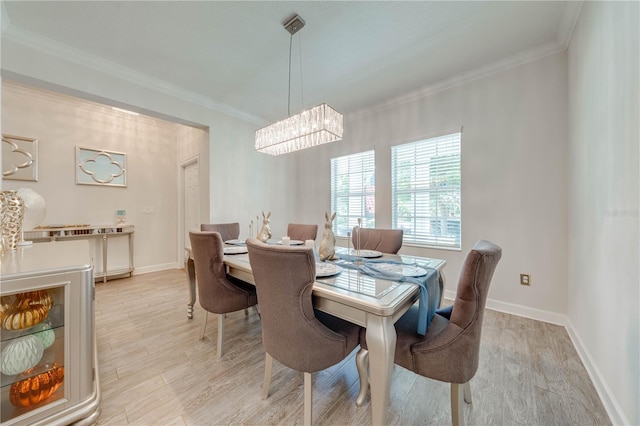 dining area featuring a chandelier, baseboards, light wood-type flooring, and crown molding