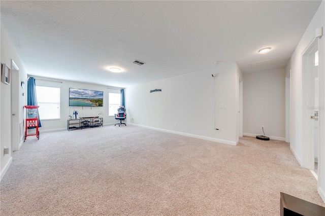 unfurnished living room with visible vents, baseboards, and carpet floors