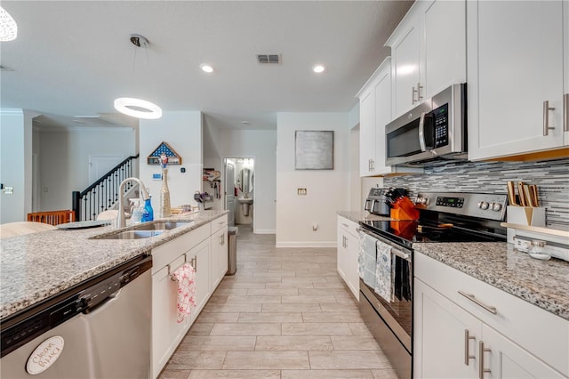 kitchen with tasteful backsplash, visible vents, baseboards, a sink, and stainless steel appliances