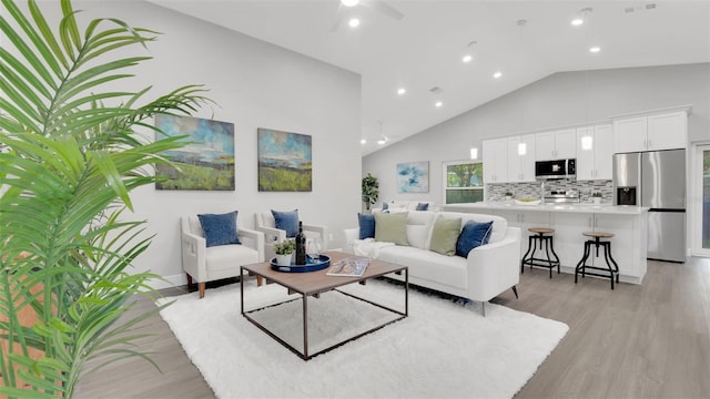 1027 Dees Dr, Oviedo, FL 32765 - living area with light wood-type flooring, recessed lighting, ceiling fan, and high vaulted ceiling