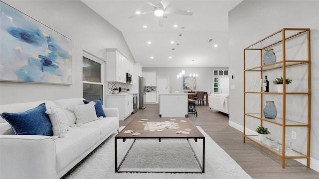 1027 Dees Dr, Oviedo, FL 32765 - living room with lofted ceiling, a ceiling fan, a chandelier, light wood finished floors, and recessed lighting