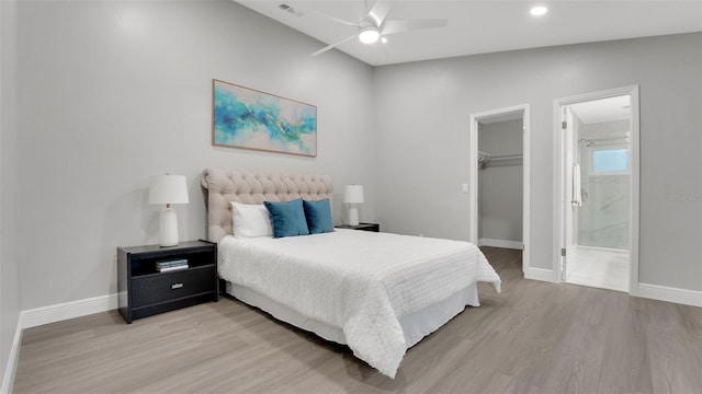 1027 Dees Dr, Oviedo, FL 32765 - bedroom featuring light wood-style flooring, a walk in closet, ensuite bath, a closet, and recessed lighting