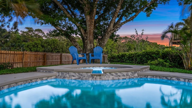1027 Dees Dr, Oviedo, FL 32765 - pool at dusk with an in-ground hot tub