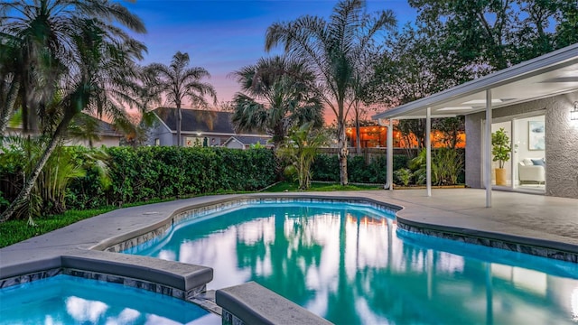 1027 Dees Dr, Oviedo, FL 32765 - pool at dusk featuring a patio area