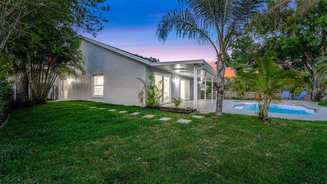 1027 Dees Dr, Oviedo, FL 32765 - back of house at dusk featuring stucco siding and a patio area
