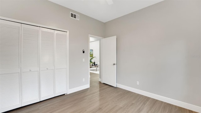 1027 Dees Dr, Oviedo, FL 32765 - unfurnished bedroom with light wood-style floors, a closet, and ceiling fan