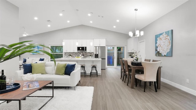 1027 Dees Dr, Oviedo, FL 32765 - living room featuring a chandelier, high vaulted ceiling, light wood-type flooring, and recessed lighting
