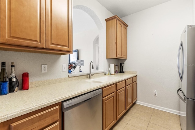 8296 Portofino Dr Unit 405, Davenport, FL 33896 - kitchen with stainless steel appliances, arched walkways, light countertops, and a sink