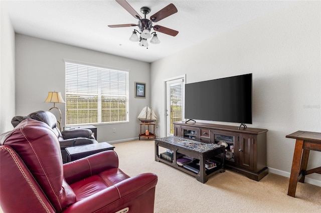 8296 Portofino Dr Unit 405, Davenport, FL 33896 - living area with baseboards, a ceiling fan, and light carpet
