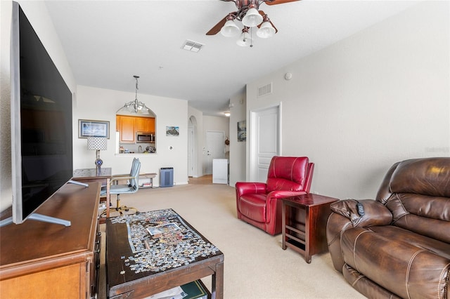 8296 Portofino Dr Unit 405, Davenport, FL 33896 - living area featuring light carpet, arched walkways, visible vents, and ceiling fan