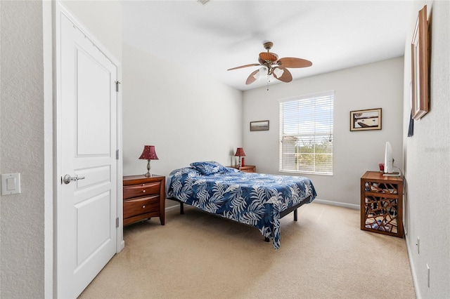 8296 Portofino Dr Unit 405, Davenport, FL 33896 - bedroom with baseboards, a ceiling fan, and light colored carpet