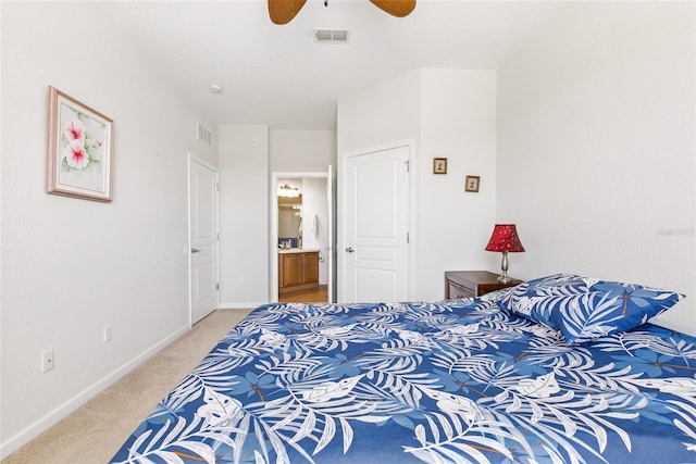 8296 Portofino Dr Unit 405, Davenport, FL 33896 - bedroom featuring ceiling fan, ensuite bathroom, visible vents, light carpet, and baseboards