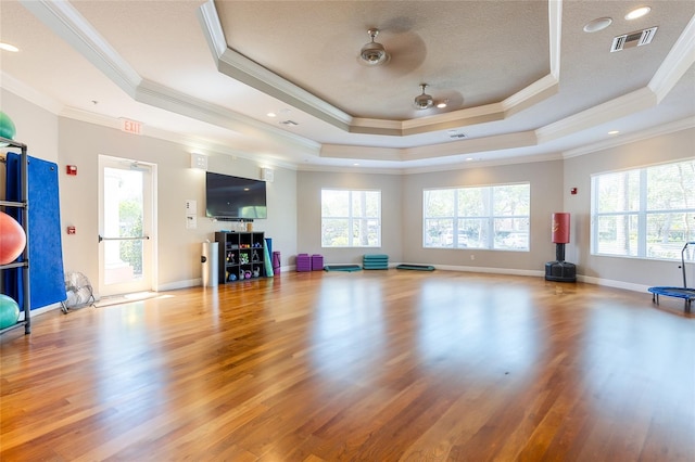 8296 Portofino Dr Unit 405, Davenport, FL 33896 - workout area featuring a wealth of natural light, visible vents, a tray ceiling, and wood finished floors