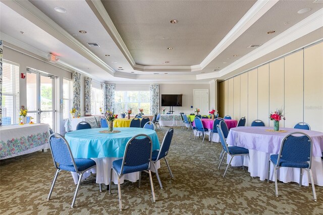 8296 Portofino Dr Unit 405, Davenport, FL 33896 - carpeted dining space featuring a tray ceiling and ornamental molding