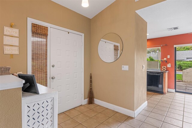 entrance foyer with light tile patterned floors, visible vents, and baseboards