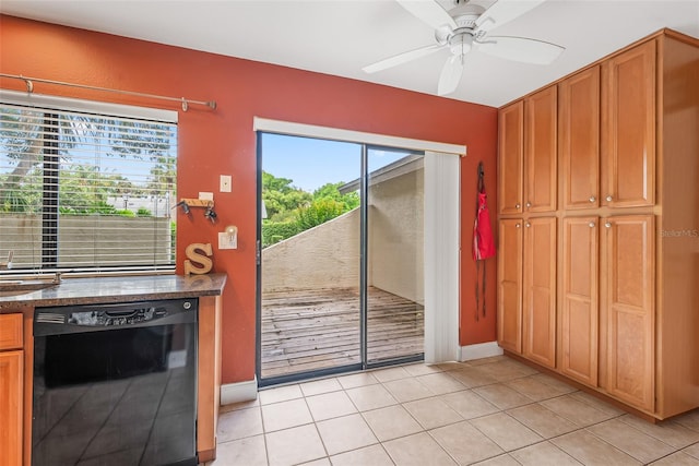 entryway featuring a sink, ceiling fan, light tile patterned flooring, and baseboards