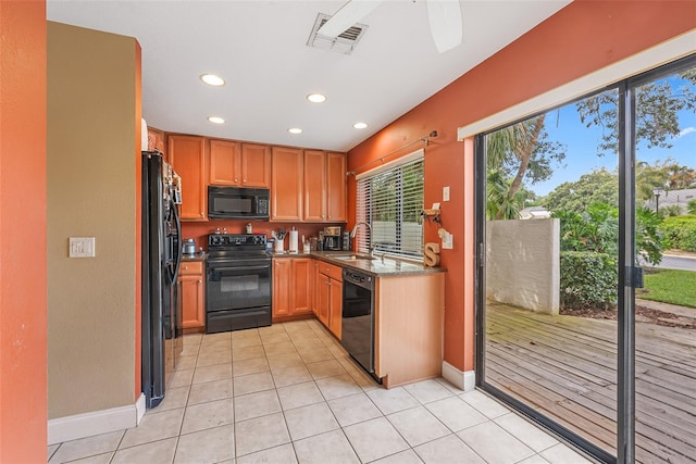 kitchen featuring visible vents, black appliances, recessed lighting, light tile patterned flooring, and a sink