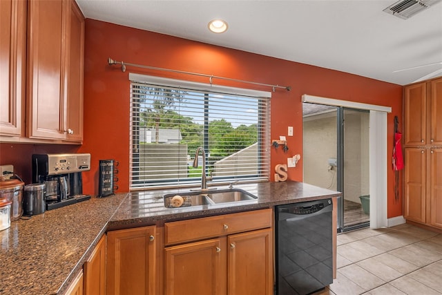 kitchen featuring light tile patterned floors, visible vents, dishwasher, a sink, and brown cabinets