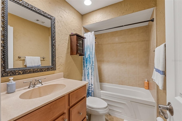 bathroom featuring vanity, a textured wall, shower / bath combo, toilet, and visible vents