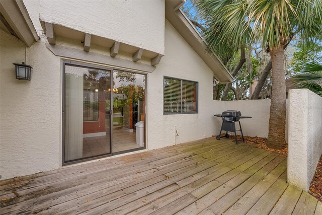 deck featuring fence and area for grilling