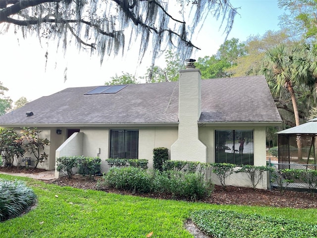 600 Fallsmead Cir, Longwood, FL 32750 - view of property exterior with stucco siding, a shingled roof, a chimney, a gazebo, and a yard