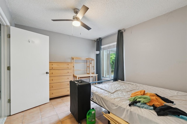 3921 SW 34th St Unit 102, Gainesville, FL 32608 - bedroom with a textured ceiling, light tile patterned floors, and a ceiling fan