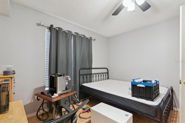3921 SW 34th St Unit 102, Gainesville, FL 32608 - bedroom featuring a textured ceiling, baseboards, and ceiling fan