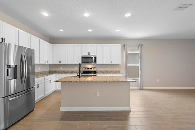 kitchen featuring stainless steel appliances, visible vents, recessed lighting, and wood tiled floor