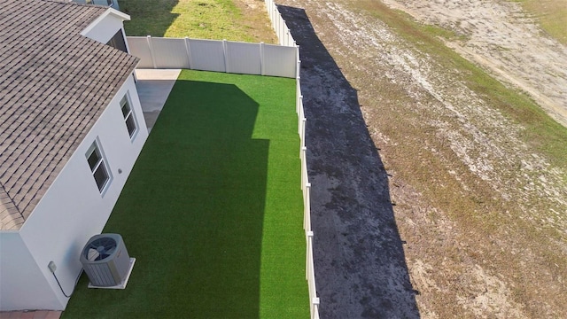 view of yard with fence and cooling unit