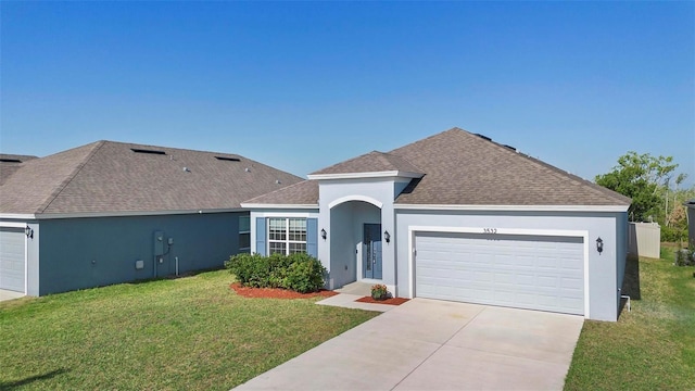 ranch-style home featuring a front lawn, roof with shingles, stucco siding, concrete driveway, and an attached garage