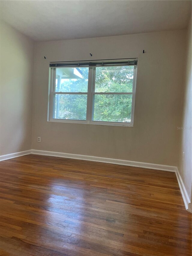 275 Virginia Dr, Winter Garden, FL 34787 - unfurnished room featuring plenty of natural light, dark wood-style flooring, and baseboards