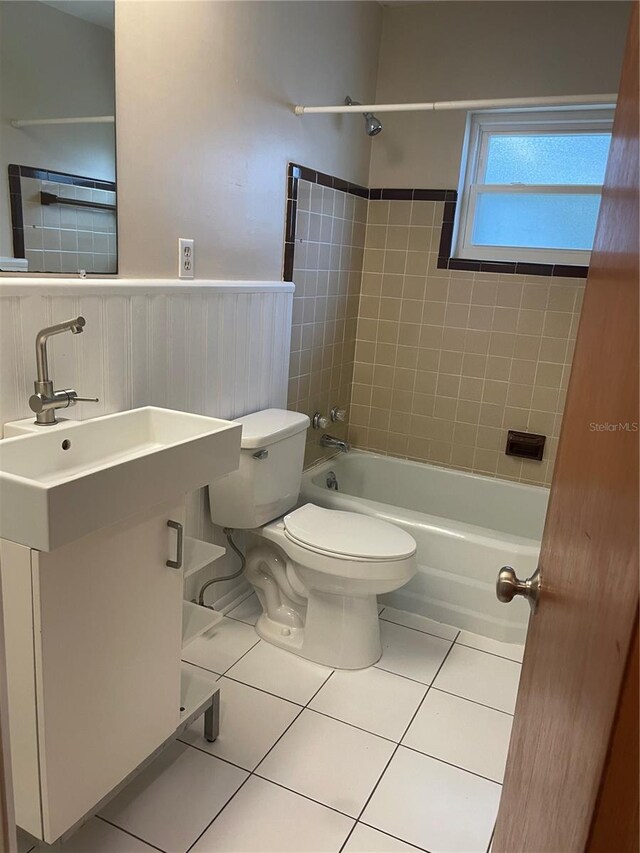 275 Virginia Dr, Winter Garden, FL 34787 - bathroom with vanity, tile patterned flooring,  shower combination, a wainscoted wall, and toilet