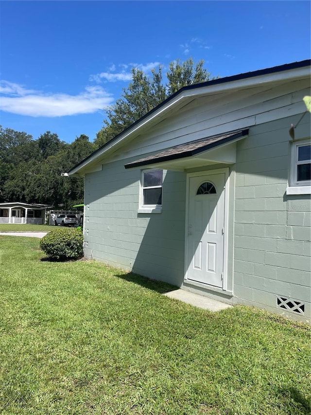 275 Virginia Dr, Winter Garden, FL 34787 - doorway to property featuring a yard and concrete block siding