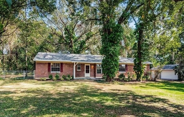 2902 Little Rd, Valrico, FL 33596 - ranch-style home featuring fence, a front lawn, and brick siding
