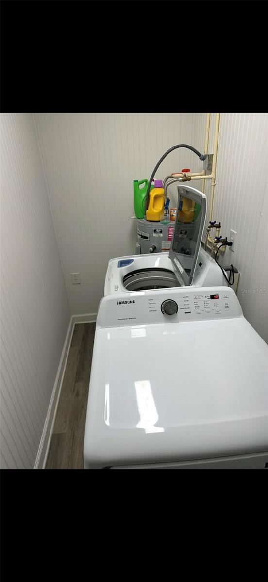 2902 Little Rd, Valrico, FL 33596 - laundry room with washer / clothes dryer, baseboards, laundry area, and wood finished floors