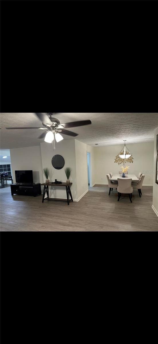 2902 Little Rd, Valrico, FL 33596 - living area featuring ceiling fan, baseboards, a textured ceiling, and wood finished floors